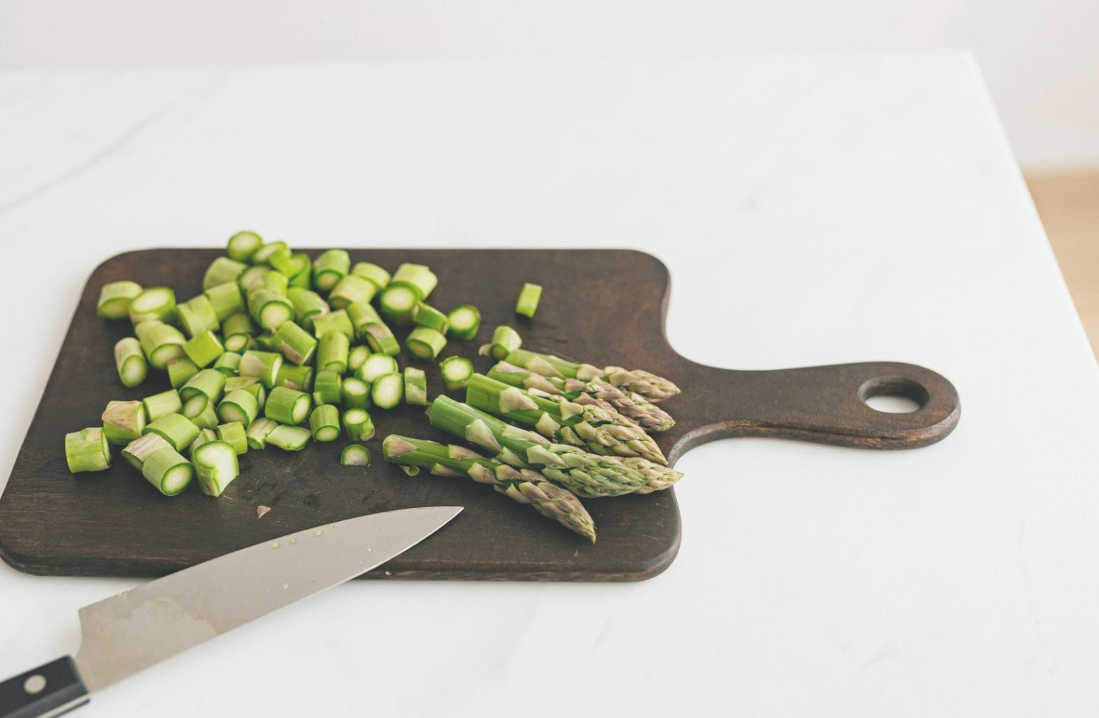 Students practicing vacuum sealing and temperature monitoring in professional kitchen environment
